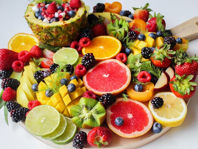 Various sliced fruits on a wooden board